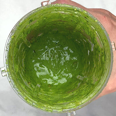 Step 2 - Make the pesto by transferring spinach, cheese, orange juice, orange zest (keep a little bit aside for garnish), garlic paste, pistachio nuts, salt, pepper and olive oil into a food processor and pulse until smooth.