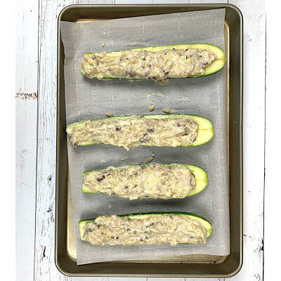 Step 5 - Add orzo, zucchini seeds, pancetta and cheese to the sauce. Taste and add salt, pepper and nutmeg if needed. Scoop sauce in the zucchini halves.