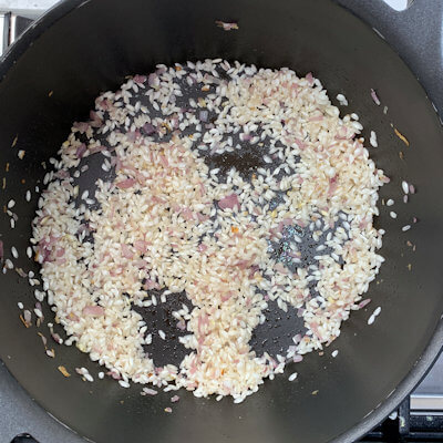 Step 2 - Add the rice and roast it by stirring it until you see white spots on the grains.
