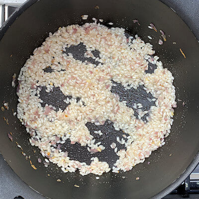 Step 3 - Deglaze (adding liquid into a pan in order to loosen the particles that are stuck to the bottom of your pan) the pan with white wine and stir until the wine is fully absorbed.