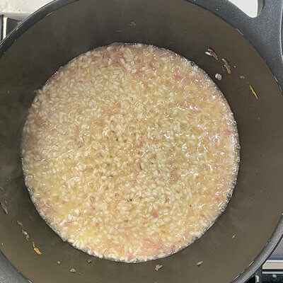 Step 4 - Add 1/2 cup of heated stock and stir until fully absorbed. Continue adding stock only after each cup is absorbed.