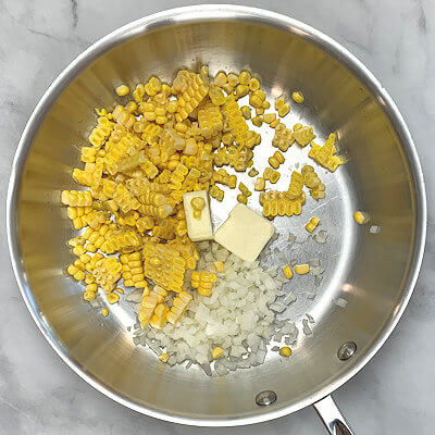 Step 1 - Heat butter in a skillet, add finely chopped onion and corn kernels. Cook and stir until the onion is translucent. Cool down.Slice the summer squash thinly (by hand or use a mandolin). Place the slices on a paper towel and sprinkle with salt. Let this sit for about 10 minutes and cover with another sheet of paper towel and dab the moisture off the summer squash.