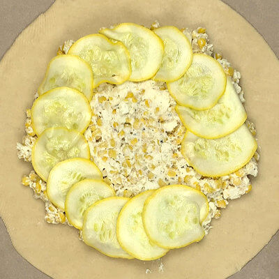 Step 4 - Transfer the slices of summer squash on top of the cheese mixture, circling from the outside in and each slice overlapping the previous one.