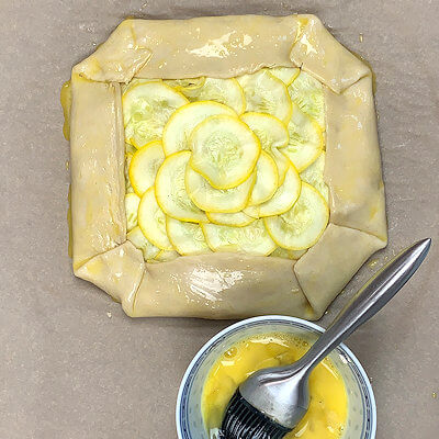 Step 6 - Brush the dough with a beaten egg.