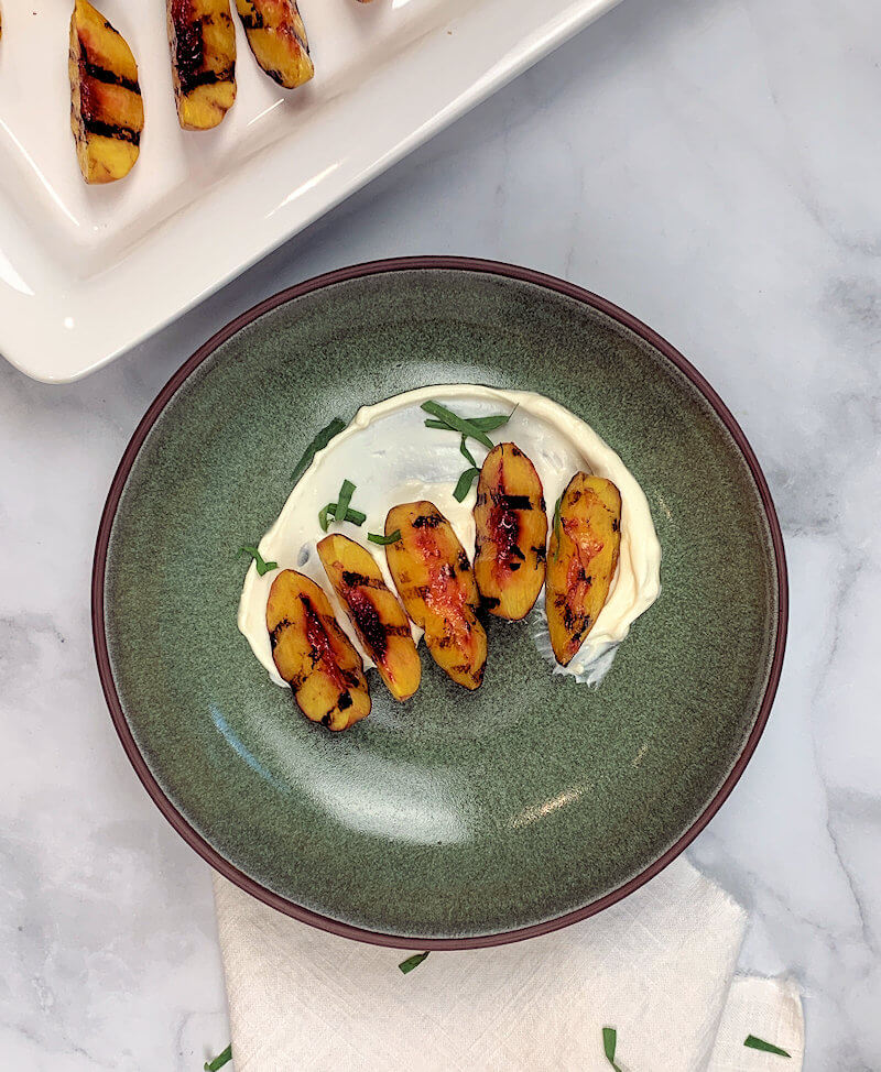 Grilled Peaches on Mascarpone cream in green bowl