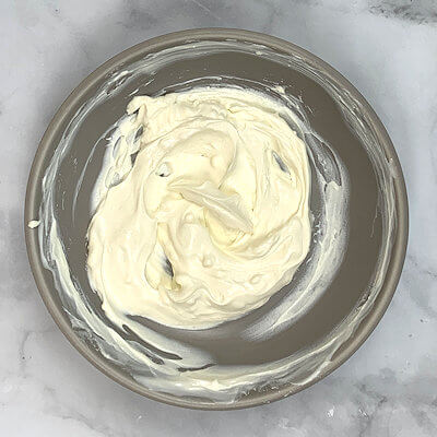 Make the Mascarpone cream by mixing Greek yogurt with honey and vanilla extract. Once that is well mixed, add the Mascarpone cheese.