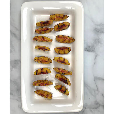 Step 4 - Transfer the grilled peach slices to a platter for easier plating and to stop the cooking process.