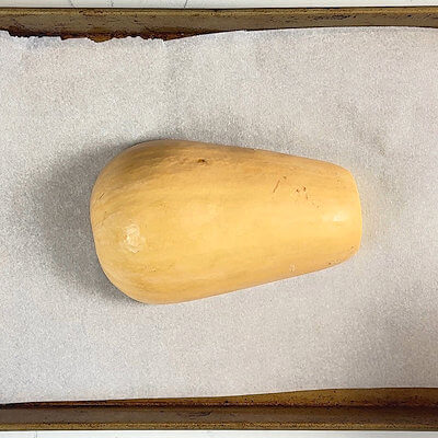 Step 1 - Preheat an oven to 425°F. Cut a butternut squash in half (we will only one one half for this recipe). Place the squash on a baking sheet lined with parchment paper and roast for about 25 minutes or until the squash is soft. 