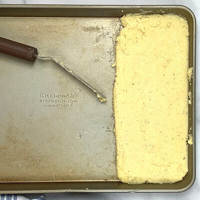 Step 5 - Moisten part of a baking sheet with water and spread the semolina mixture onto the baking sheet.