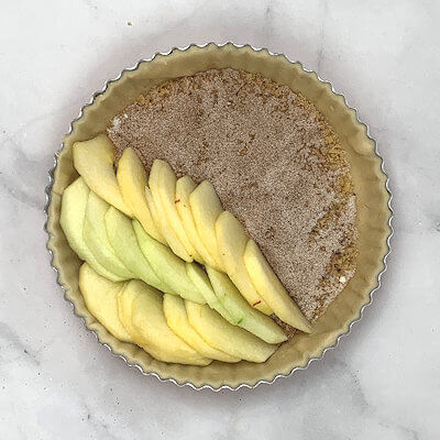 Step 5 - Peel the apples and slice them thinly. For this thin tart, I prefer to peel the apples, but keeping the skin on will work as well. Place the slices in the pie form. You can do this in rows, in circles, each slice slightly overlapping the previous or create a pattern of your own.