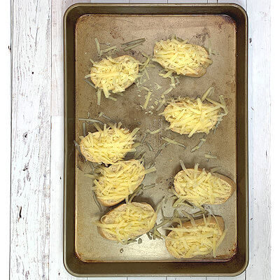 Step 4 - Make the Gruyere Toast by placing slices of baguette (French bread) in a single layer on a baking sheet and bake for about 7 minutes in a 375°F oven or until toasted. Sprinkle each slice with grated cheese and bake another 5 minutes or until the cheese is melted.