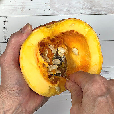 Step 3 - Scoop the seeds and the strings out of the pumpkin and sprinkle the pumpkin halves with salt.If you feel wrong about throwing away the pumpkin seeds, roast them and snack away.