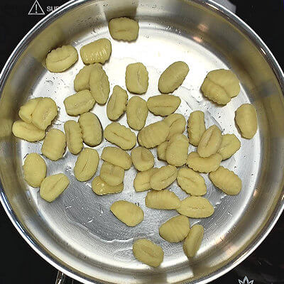 Step 1 - Heat olive oil in a skillet and add the gnocchi. Heat on medium until gnocchi start to brown and plump up.