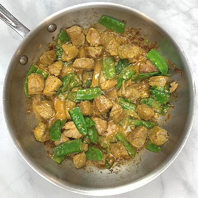 Step 3 - Add coconut milk, ginger and red curry paste.