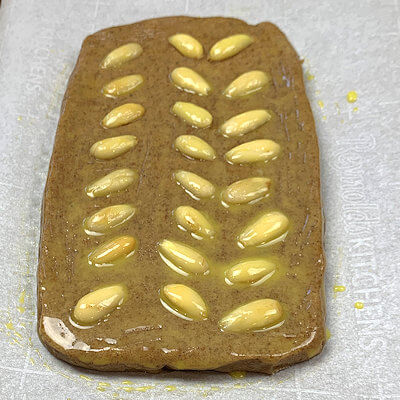 Step 3 - Push the almond halves or slivers slightly into the dough in any pattern you like. This step is optional.