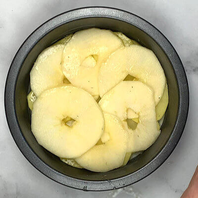 Step 4 - Add a layer of apple slices on top of the potato slices.