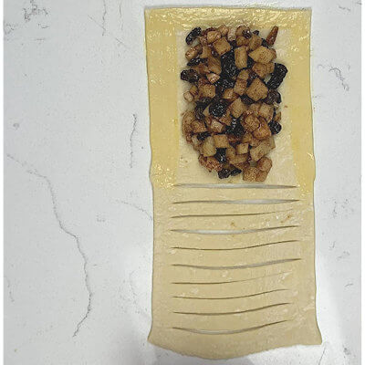Step 4 - Place the apple mixture on the uncut half, again leaving about 1/2-inch border. Brush the border surrounding the apple filling with egg wash.