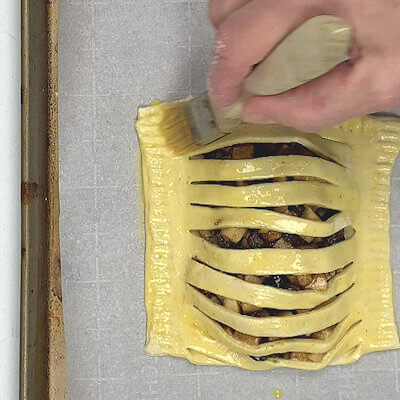 Step 6 - Place the applecarré on a baking sheet, lined with parchment paper. Brush the entire applecarré with egg wash and transfer to a 400°F. oven.