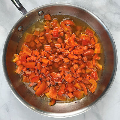 Step 3 - At the same time, heat a olive oil in a skillet and add onion, and garlic and sauté until translucent. Add bell pepper, carrots, chicken broth and salt. Cover the pan and cook until the carrots are fork tender. This takes about 5-10 minutes, depending on the size of the carrot pieces.
