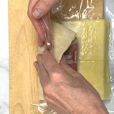 Step 7 - Roll the dough over the pork until it meets the other side of the dough. Delicately, massage the dough ends to close the seam.