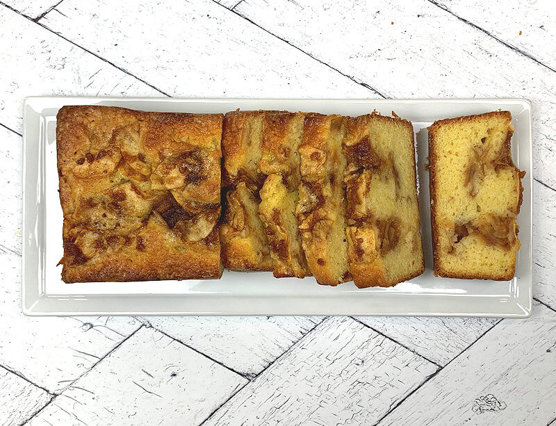 Entire cake on white place, sliced.