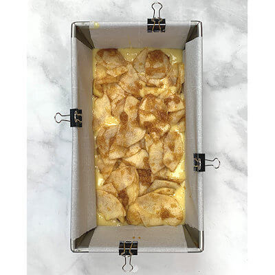 Step 3 - Pour half of the batter in the bottom of the cake form and top that with half of the apple mixture,