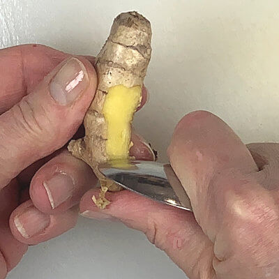 Ginger root has a very uneven shape, so peeling it as if you peel vegetables may not be that simple. Furthermore, using a vegetable peeler or knife my cut off more ginger flesh than you like. Using a small spoon however is the perfect solution to reach all the nooks and crannies, while only peeling away the skin and not the flesh.