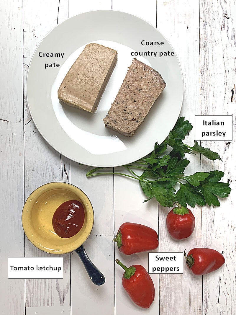 White plate with smooth and coarse pate, as well as other ingredients of pate stuffed pepper slices