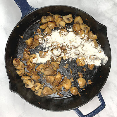 Step 5 - Lower heat, add flour to the skillet and stir. 