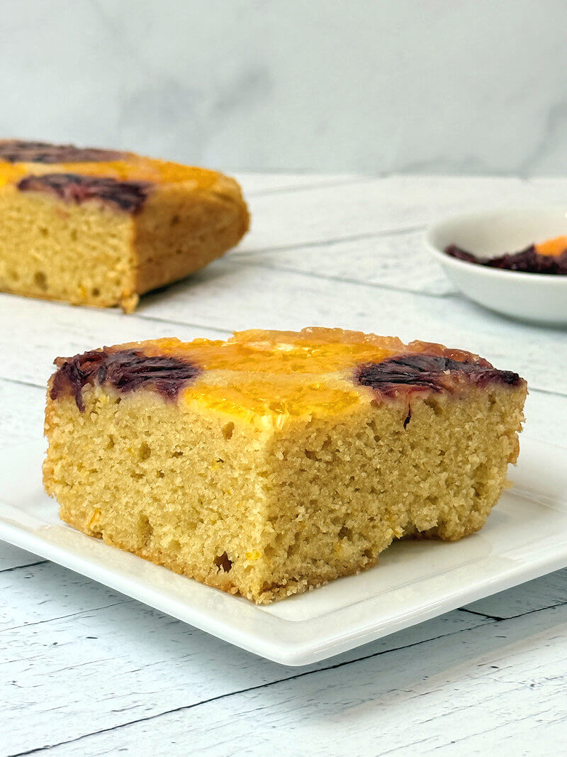 Close up of cut orange almond cake.