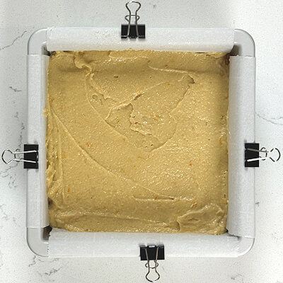 Step 6 - Now it’s time to add the batter. Place many large dollops over the orange slices and spread those towards each other to cover the entire surface. This way you can ‘connect’ the batter without moving the fruit slices around.