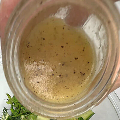 Step 5 - Bring the same water back to a boil again and add the orzo. Cook the pasta according to the directions on the packaging. Drain and cool. Make the dressing by adding to a small jar, the olive oil, white wine vinegar, maple syrup, Dijon mustard and salt & pepper. Whisk or shake until well combined.