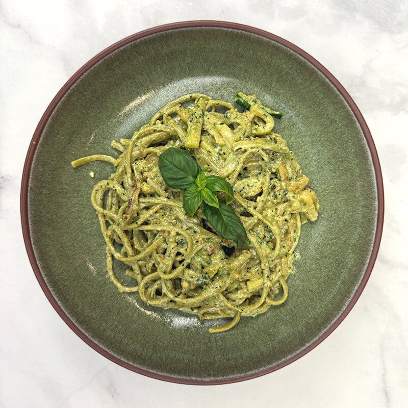 Green bowl with zucchini pasta with pistachio-basil pesto