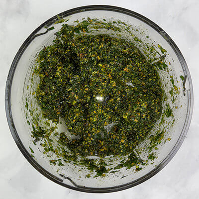 Make the Pistachio-Basil Pesto by processing pistachios, basil leaves, parsley, olive oil, salt & pepper. You can process it until fairly smooth or coarse.