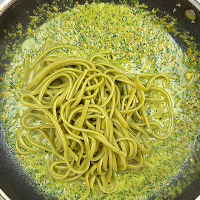 Step 4 - Drain pasta (keep some pasta water aside) and add it to the skillet with pesto. Toss pasta with sauce.