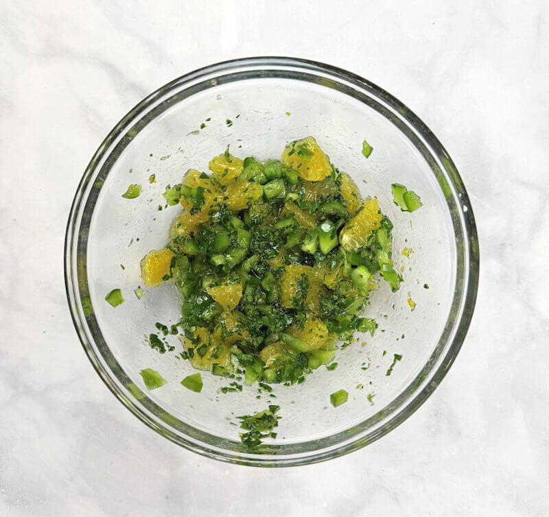 Glass bowl with orange pepper salsa