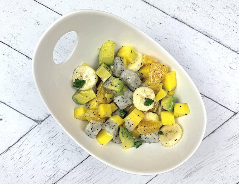 Top down look into bowl with tropical fruit salad.