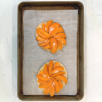 Step 4 - Place the apricot wedges on the baked pie circles and cover the pie bottoms completely. Sprinkle with a little bit of sugar and place them back into the oven.Bake at 350°F. for about 30 minutes.