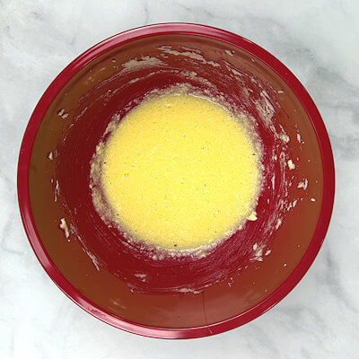Step 1 - Mix the butter and the sugar until white. Add the eggs and the lemon juice and mix again. You will have a mixture that looks like curdled.