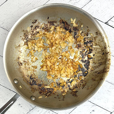 Step 2 - If needed, add more butter and oil to the skillet and saute the onion until translucent. The left-over brown bits of the chicken will be loosen later.