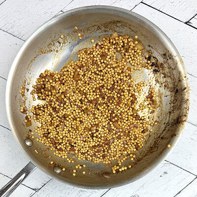 Step 4 - Add white wine and loosen the brown bits off the bottom. Allow the wine to evaporate.