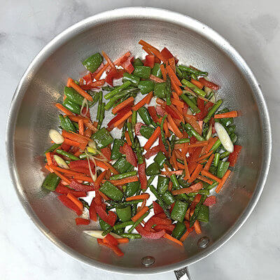 Step 3 - Add the red bell pepper, carrots and scallion and saute 2 minutes.