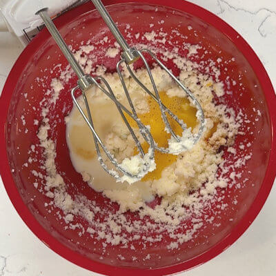 Step 2 - Mix in milk, egg and vanilla extract.