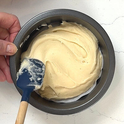 Step 4 - Transfer the strawberry cake mixture to a buttered 6-inch pie dish and level the top.