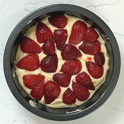 Step 5 - Arrange the cut strawberries on top of the cake batter. Try to get as many strawberries in there and don't worry about any particular way to arrange them.
