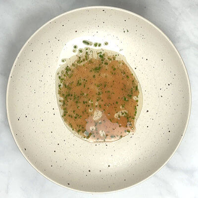 Step 2 - Make the dressing by mixing red wine vinegar, maple syrup, mustard, chives, salt & pepper. Pour the dressing into a salad bowl.