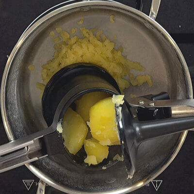 Step 2 - Drain the potatoes (keep some potato water for later) and discard the garlic cove. Use a potato ricer, a food mill or a fine mesh sieve to mash the potatoes.