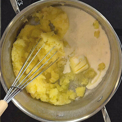 Step 3 -Add the cream and butter to the mashed potatoes and start mixing. 