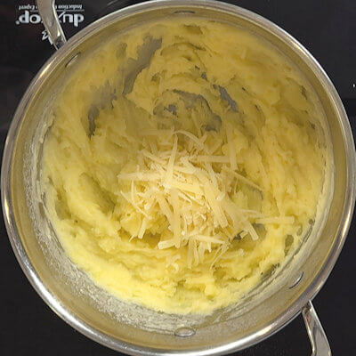 Step 4 - Add the grated cheese in various steps. Make sure you mix it thoroughly.
