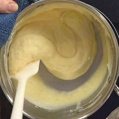 Step 5 - Keep on mixing, add a little bit of potato water, and mix some more - until you have had a proper upper work-out. The cheese melts, and will from a gooey, strechy mixture. 